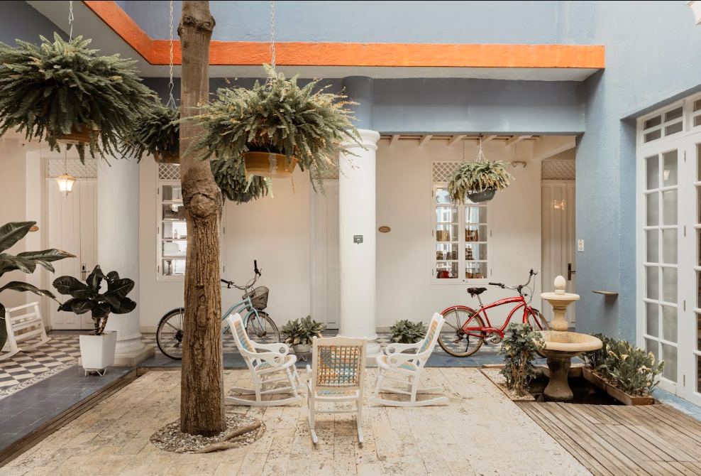 Patio interior de Hotel Placita Vieja con baldosas coloniales y bicicleta